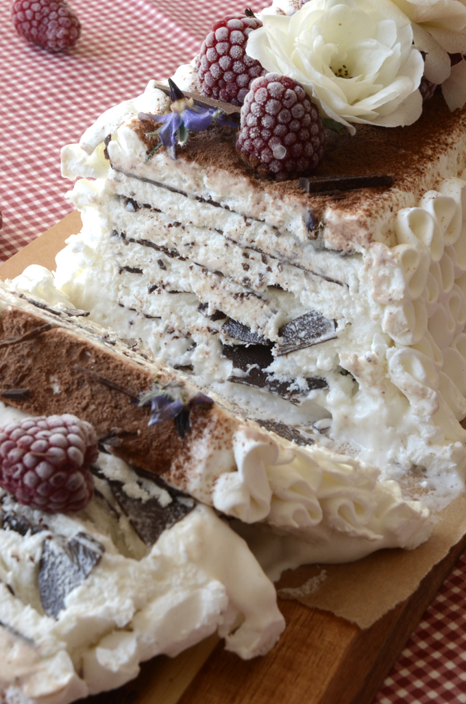 A homemade Vienetta ice cream has ben sliced, revealing crispy thin layers of chocolate in the ice cream cake